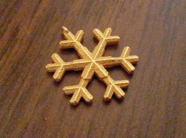 A wee snowflake pendant in Polished Gold Steel