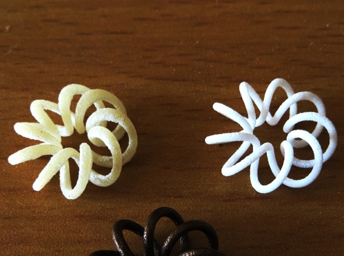(9, 2) Spiral Torus 3d printed Left: elastoplastic.  Right: strong & flexible plastic. 