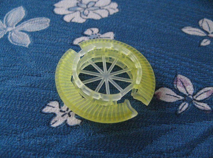 Disk Pendant: Tritium, Part 2 of 2 3d printed The yellow colour comes from an oily solvent that is used to remove the unhardened printing material inside the model.