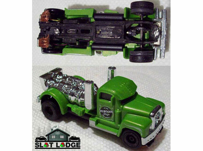 Original SL1 - Narrow: HO Slot Car Chassis 3d printed SL1, painted black, under a 1/64 scale toy truck. 
