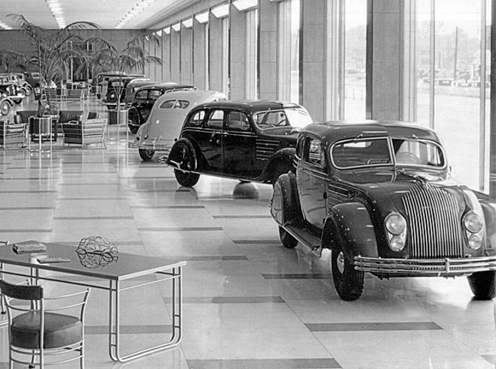 1934 Chrysler Airflow Dealer Promo 16" Frame model 3d printed 1934 Chrysler showroom. A miniature frame model sits on the table in the foreground.