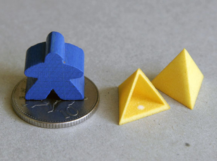 Tetrahedron Capstones (x5) 3d printed Showing scale with ten pence coin and meeple.  Also shows the sprue cut-off point inside the capstone.