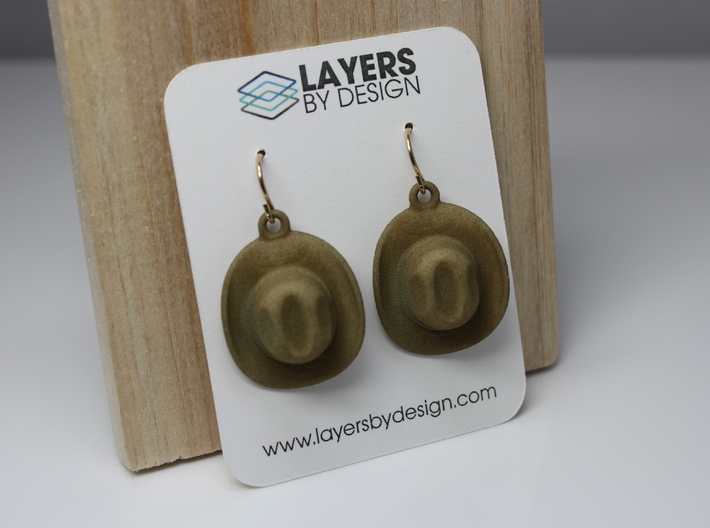 Cowboy Hat Earrings 3d printed Shown in Strong & Flexible Plastic, Dyed Beige (Color Not available at Shapeways, please contact the designer).