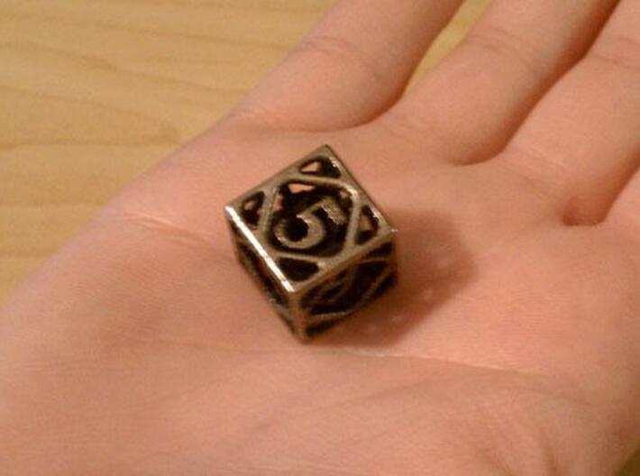 Cage d6 3d printed In stainless steel and inked.
