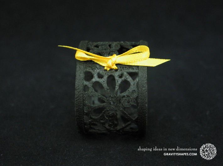 A small napkin ring with Mosaic-3b 3d printed The photo shows an own print (FDM print) made of black wood incl. decorative lacing.