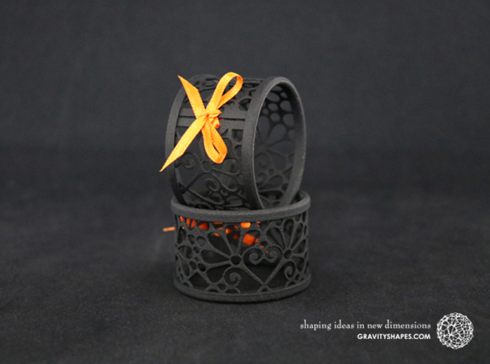 A large napkin ring with Mosaic-3b 3d printed The photo shows prints made of black strong and flexible incl. orange lacing.