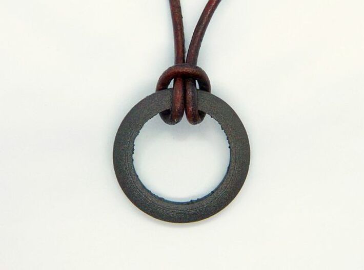 Ring shaped pendant with a raw band inside 3d printed