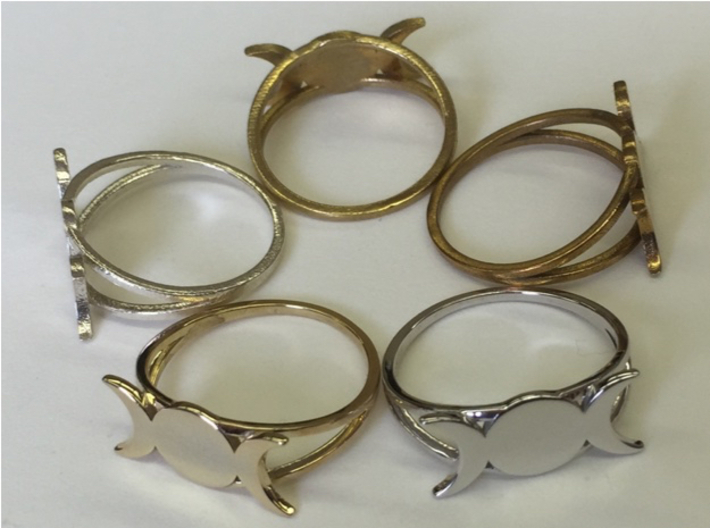 Triple Moon Ring 3d printed A ring of rings: Going clockwise starting at seven o'clock, there's 14k gold-plated brass (polished), raw silver, raw brass, raw bronze, rhodium plated brass (polished). 