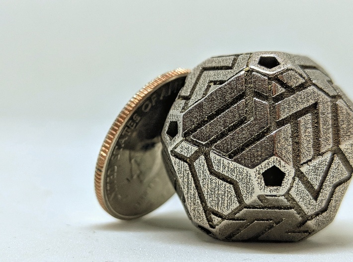 Cacography - D20 3d printed Quarter for scale. Please note that SS prints may arrive with polishing media in crevices. It can be removed fairly easily with an X-acto knife or stiff brush.