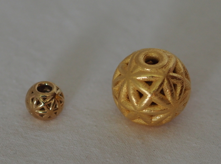 torus_pearl_loop_type8_thick 3d printed Polished Brass is Small and Polished Gold Steel is Medium.