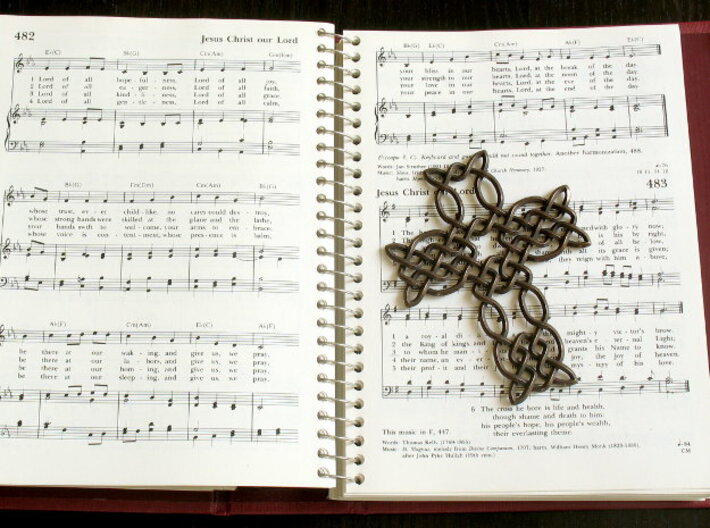Celtic knot cross 3d printed Printed in polished bronze steel, with hymnal for scale!