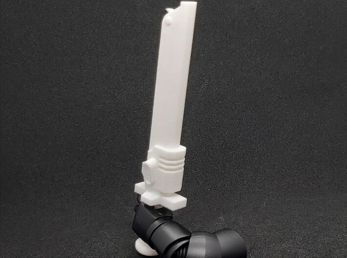 Action Figure Chainsword - Right Handed 3d printed Printed in White Natural Versatile Plastic, held by the hand of a 1:12 scale action figure arm, Left Handed version shown