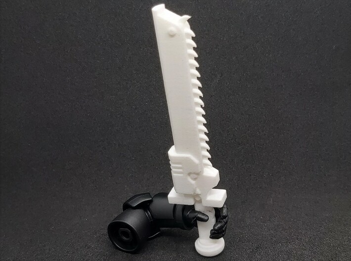 Action Figure Chainsword - Right Handed 3d printed Printed in White Natural Versatile Plastic, held by the hand of a 1:12 scale action figure arm, Left Handed version shown