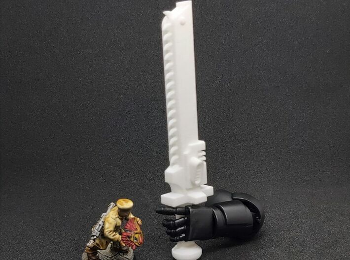 Action Figure Chainsword - Right Handed 3d printed Printed in White Natural Versatile Plastic, held by the hand of a 1:12 scale action figure arm, with a 28mm heroic scale model, Left Handed version shown