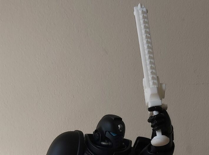 Action Figure Chainsword - Right Handed 3d printed Printed in White Natural Versatile Plastic, held by the hand of a 1:12 scale action figure, Left Handed version shown