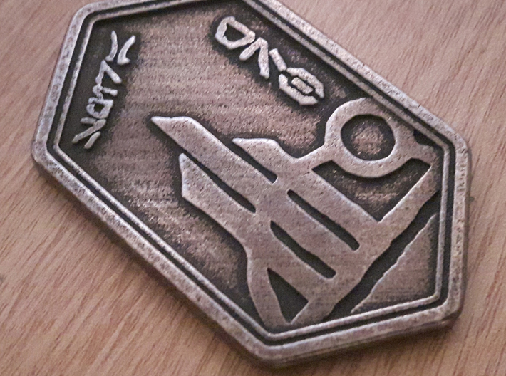 Spira coin 3d printed Metal print in bronze steel.