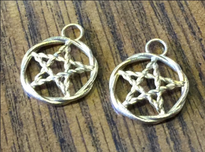 Woven pentacle earrings 3d printed The pair of woven pentacle earrings in raw brass.