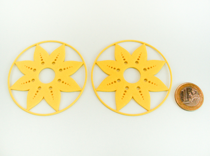 Sunflower Hoop Earrings 60mm 3d printed Sunflower Hoop Earrings 60mm printed in Yellow Strong & Flexible Polished with 1€ coin for scale.