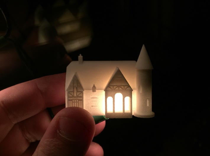 Alton Haunted house 3d printed In white with a fairy light inside showing the detail, it also shows the scale of the model