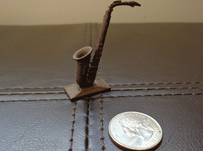 Alto Saxophone (Metals) 3d printed Polished bronze steel saxophone next to a U.S. quarter for scale. 